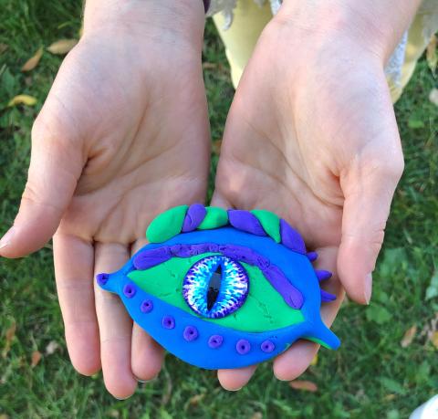 child's hands holding artwork