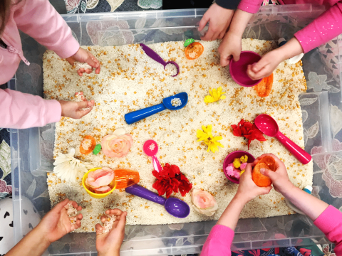 kids playing in rice bin