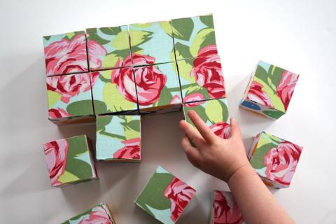 floral blocks in a puzzle with small hand