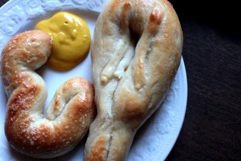 soft homebaked pretzels on a plate with mustard