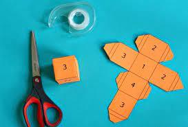 blue background with math cube cut out pattern and scissors