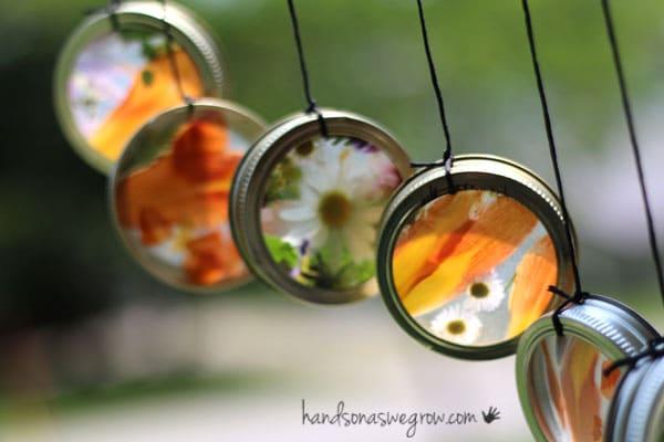 small metal lids with see through images hanging with string