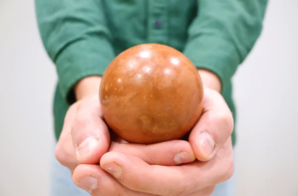 hands holding dorodango